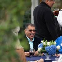 Table of faculty and staff in conversation and laughing